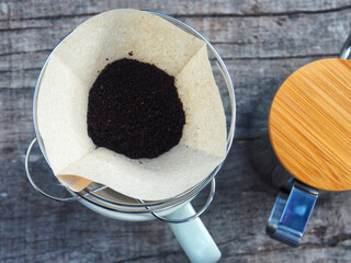 coffee dripping and black ice coffee on wood table with lemon 