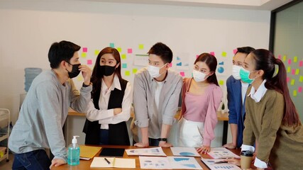 New normal group of Business man and woman wearing face mask meeting and working together for discussion and brainstroming to get ideas or marketing solution with social distance due virus pandemic - Powered by Adobe