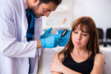 Young woman visiting male doctor dermatologist