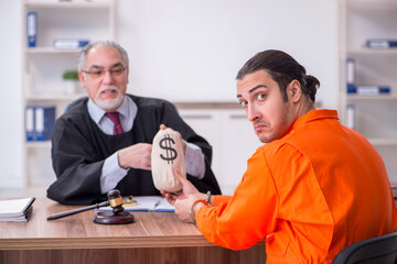 Old male judge meeting with young captive in courthouse