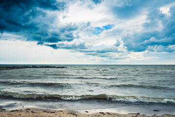 Storming sea with dark clouds in the autumn's morning. Sea landscape.