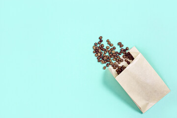 Roasted coffee beans in paper packaging with place for text.