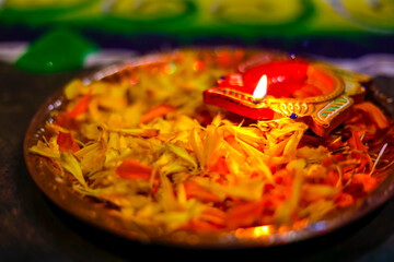 Indian Festival Diwali , lamp and marigold flower petals in pooja thali