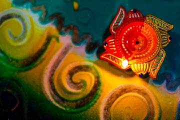 Indian Festival Diwali , lamp on colorful rangoli design