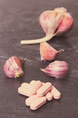 Garlic and medical pills, choice between healthy nutrition and supplements