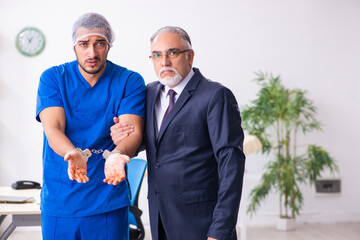 Male doctor in courthouse meeting with advocate