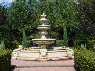 Naklejka premium Beautiful figured fountain in the garden park. Landscaping. Summer sunny day