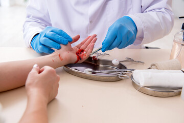 Hand injured woman visiting male doctor