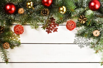 Fototapeta na wymiar Christmas, white background with fir tree and decoration on white wooden board. Christmas wallpaper. Christmas, New Year's composition with copy space for text. Flat lay, top view