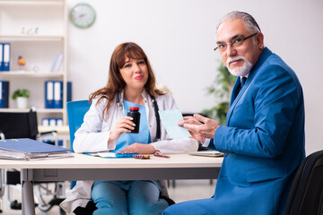 Fototapeta premium Old businessman visiting young female doctor