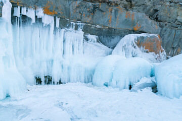 Frost ice on black rock cave, Russia winter season natural landscape background