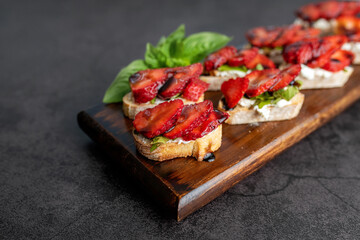Bruschetta Sandwich with strawberries, soft goat cheese, basil and balsamic glaze, served as an appetizer 