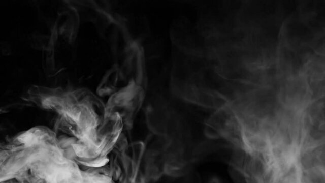 white smoke on a black background. Slow motion. Vape smoke. Texture of  cigarette smoke clud.