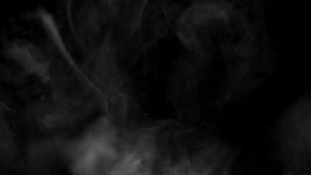 Texture of white smoke on a black background. Slow motion. Vape smoke. cigarette smoke clud.