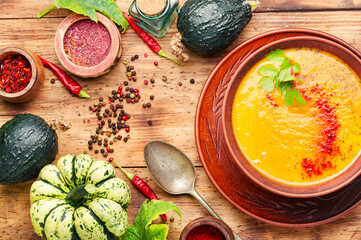 Pumpkin soup on wooden table