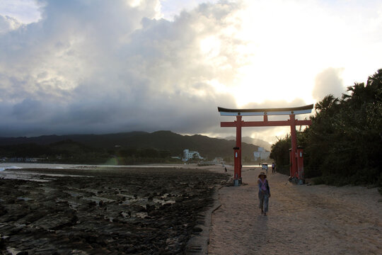 Visitors at entrance torii gate of Aoshima Shrine in the island. Located in Miyazaki