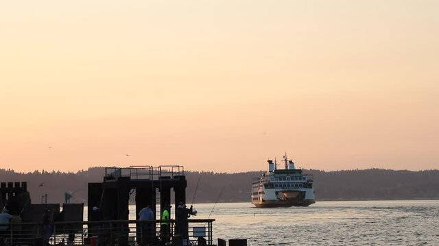 Mukilteo Ferry Leaves Dock To Cross Puget Sound In Washington State At Sunset