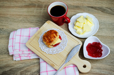 Scone homemade with strawberry jam and butter and coffee drinks backgrounds