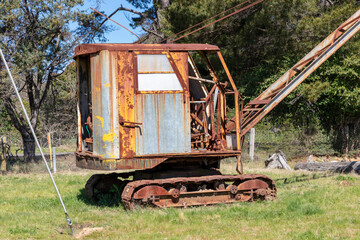 An old rusty crane in a green field in regional Australia