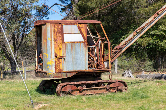 An old rusty crane in a green field in regional Australia