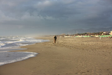 relaxing walks on the sandy beach of Versilia on a sunny day in Italian winter