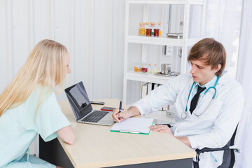 A doctor diagnoses the patient's condition.