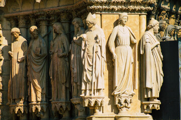 View of the exterior facade of the Roman Catholic Notre Dame de Reims Cathedral, a historical...