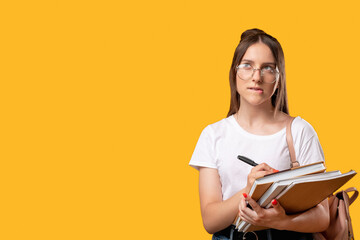 Doubt face. Education courses. Puzzled woman in glasses writing ideas in notebook. Isolated on...