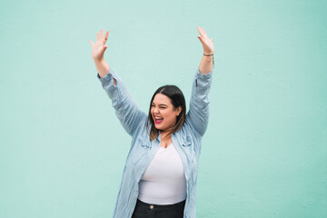 Young plus size woman celebrating victory.