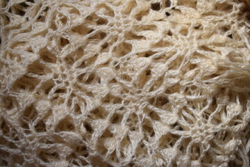 ivory crochet background, crochet motifs, plaid knitted shawl close up