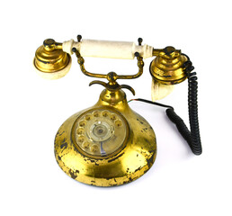 An antique tabletop phone is placed on a white background and the back is white. Made of brass,...