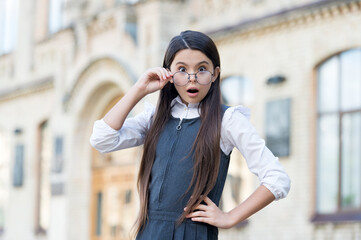 Wow. Surprised child look through glasses with open mouth. Back to school fashion. School uniform. Formal education. Surprise in learning. Private teaching. Education concept. Very surprising
