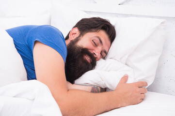 What a great morning. sleepy guy relax in bedroom. early morning. getting rest your body needs. bed is so comfortable. peaceful mature male relaxing on pillow. bearded man smiling in bed