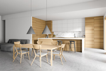 White and wooden kitchen with table and sofa