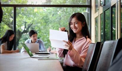 Happy excited successful businesswoman in her office.