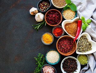 Various spices in a bowls on a black