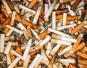 Cigarette butts many in the ashtray.
