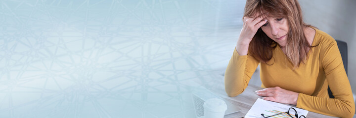 Exhausted businesswoman sitting in office; panoramic banner