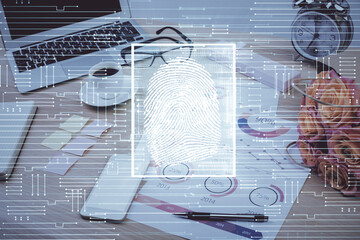 Computer on desktop in office with finger print drawing. Double exposure. Concept of business data security.