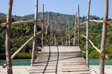 wooden bridge over the river pololem, india