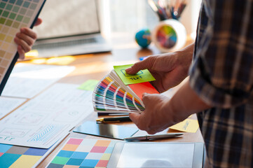 Designers carry color swatches to design websites and applications.