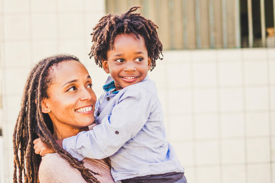 Happy Couple Black African Skin People Mother And Son Young Together Have Fun And Enjoy The Outdoor Leisure Activity In The City - Single Mom With Litthe Child Smile - Playful Family Love Concept