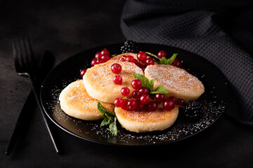 cottage cheese pancakes with red currants, mint and powdered sugar