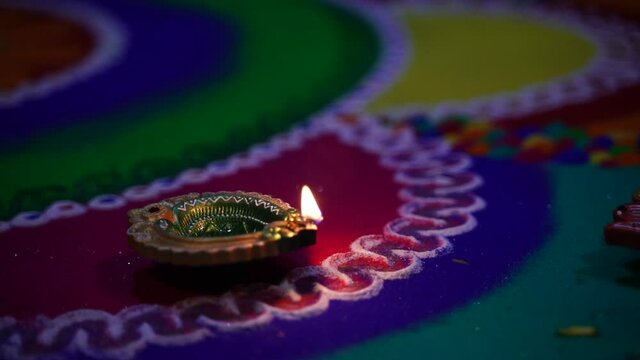 Indian Festival Diwali , lamp on colorful rangoli design