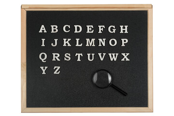 English alphabet letters on blackboard and magnifying glass. Education concept