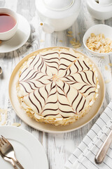 Esterhazy- traditional cake with almonds and pralines on a white wooden background . Hungarian, Austrian dessert.
