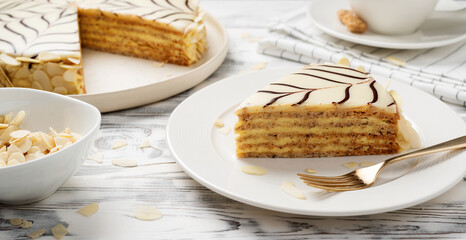 Esterhazy- traditional cake with almonds and pralines on a white wooden background . Hungarian, Austrian dessert.