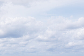 pastel blue sky with fluffy clouds