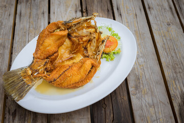 Deep Fried Snapper topped with sweet fish sauce and mango salsa.