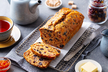 Fruit cake Bara Brith with cup of tea. Welsh traditional dessert. Grey background. Close up.